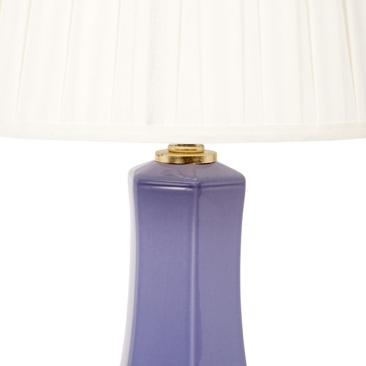 Lavender ceramic lamp body with gold top cap and white pleated shade edge