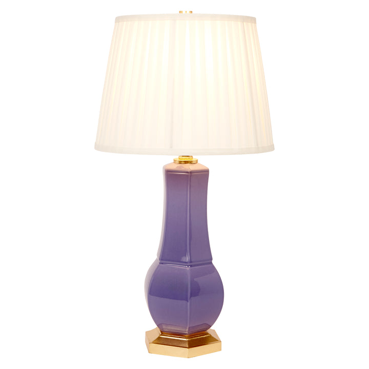 Lavender ceramic table lamp with white pleated shade, gold finial, and gold base