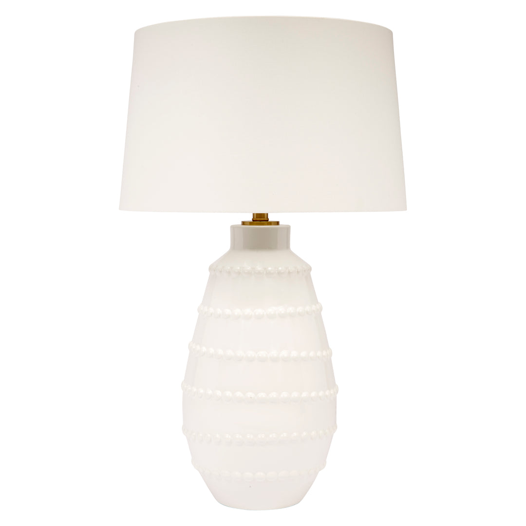 Large white ceramic table lamp with white linen shade and beaded base detail