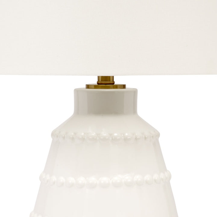 White ceramic lamp base with brass socket and ribbed beaded band collar