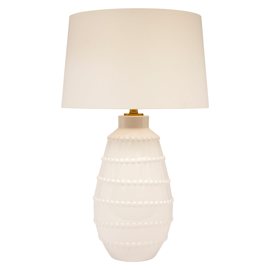 White ceramic table lamp with white linen drum shade and pearl-like bead bands