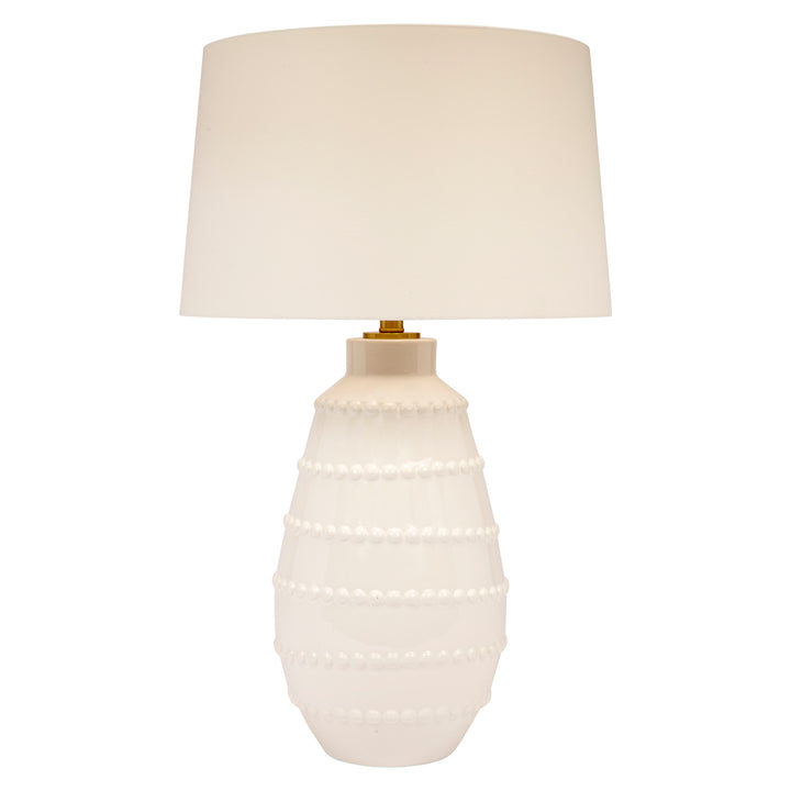 White ceramic table lamp with white linen drum shade and pearl-like bead bands