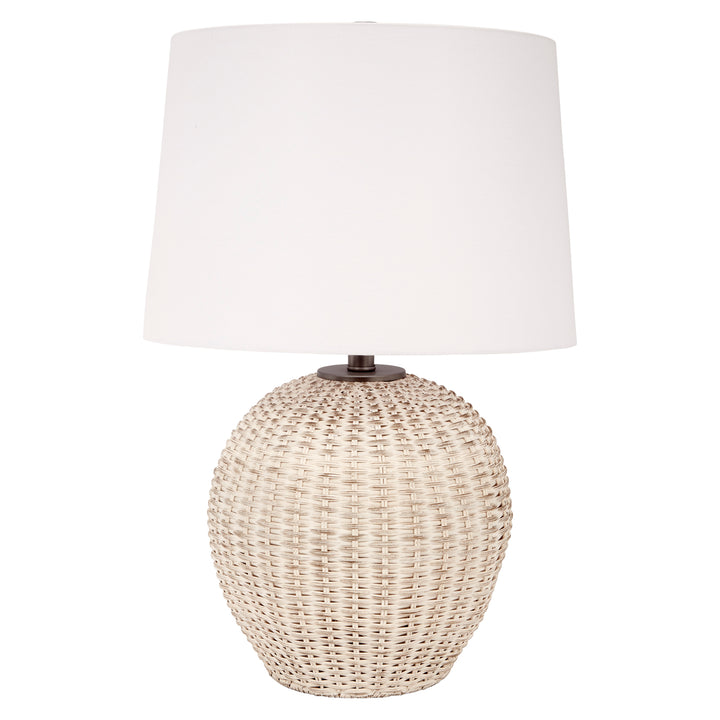Table lamp with white linen drum shade and white-washed woven rattan base