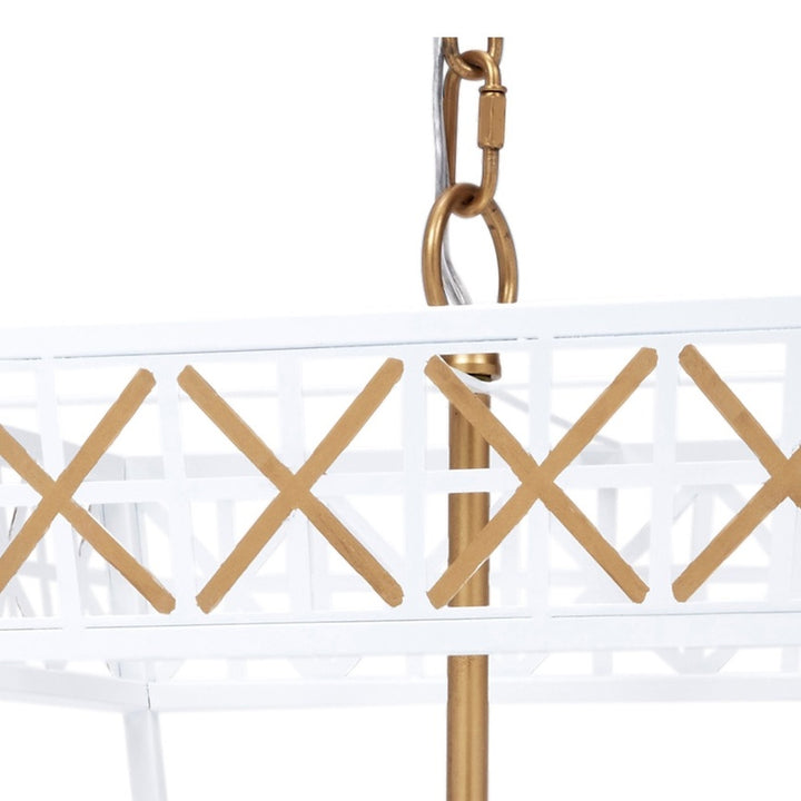 White metal lantern with gold X pattern, hanging hook detail