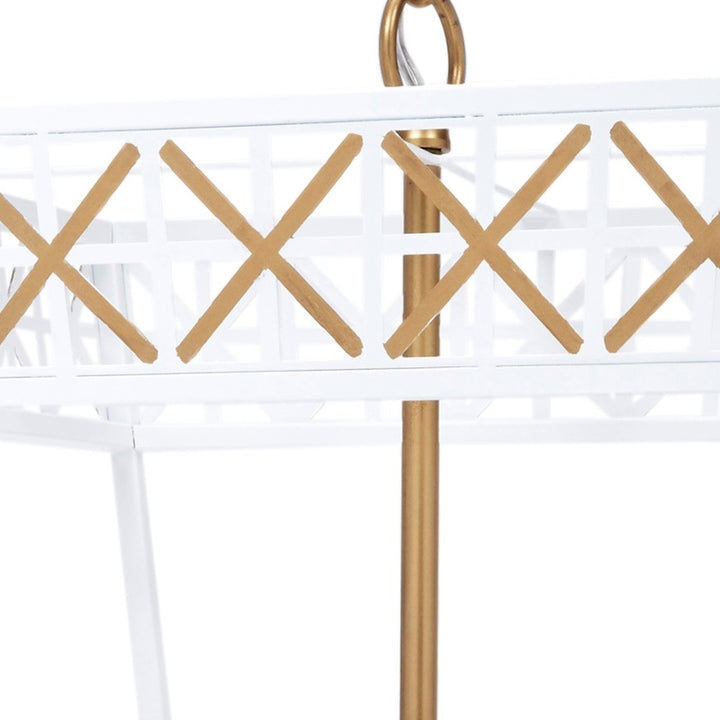 White metal lantern frame with gold X cross design and vertical posts