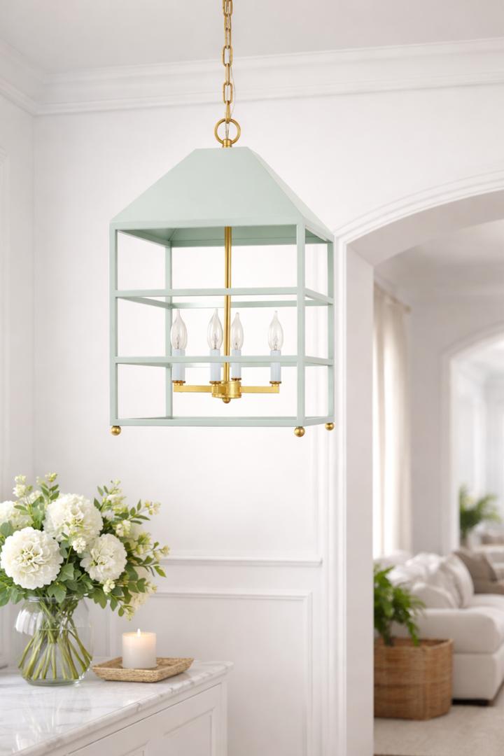 Light blue pendant light fixture in a room with white walls and a couch.