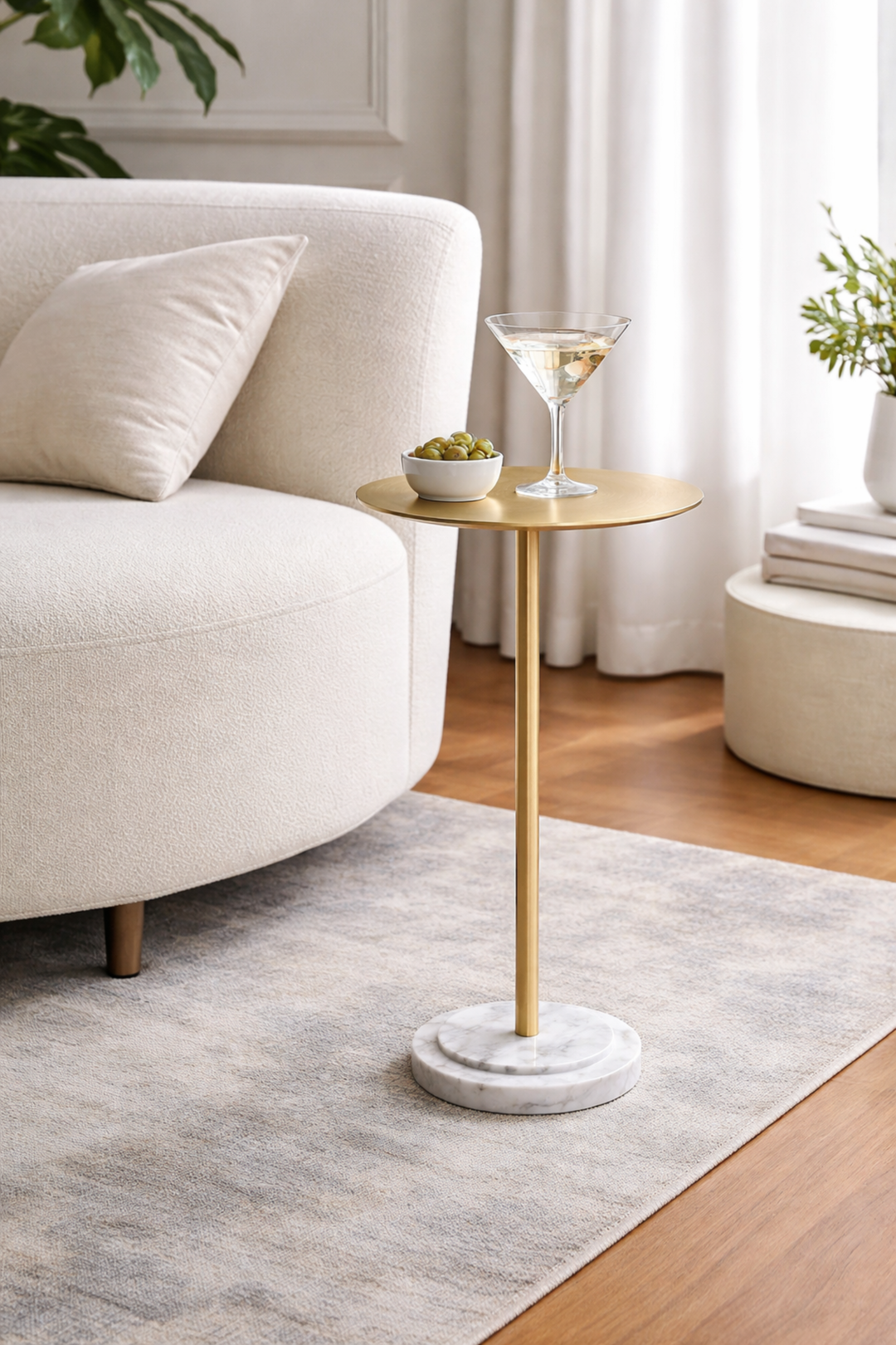 Gold side table with a marble base in a living room setting