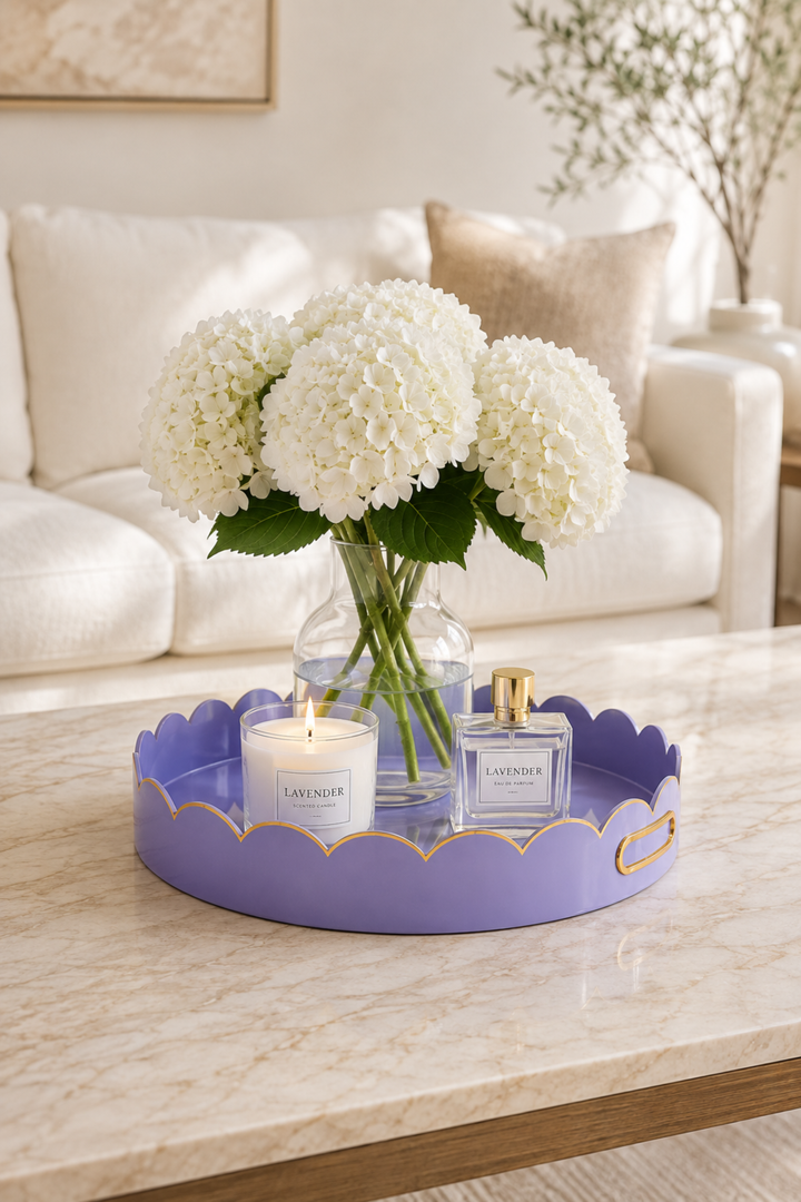 Round purple tray with gold cloud trim holding flowers and lavender candles
