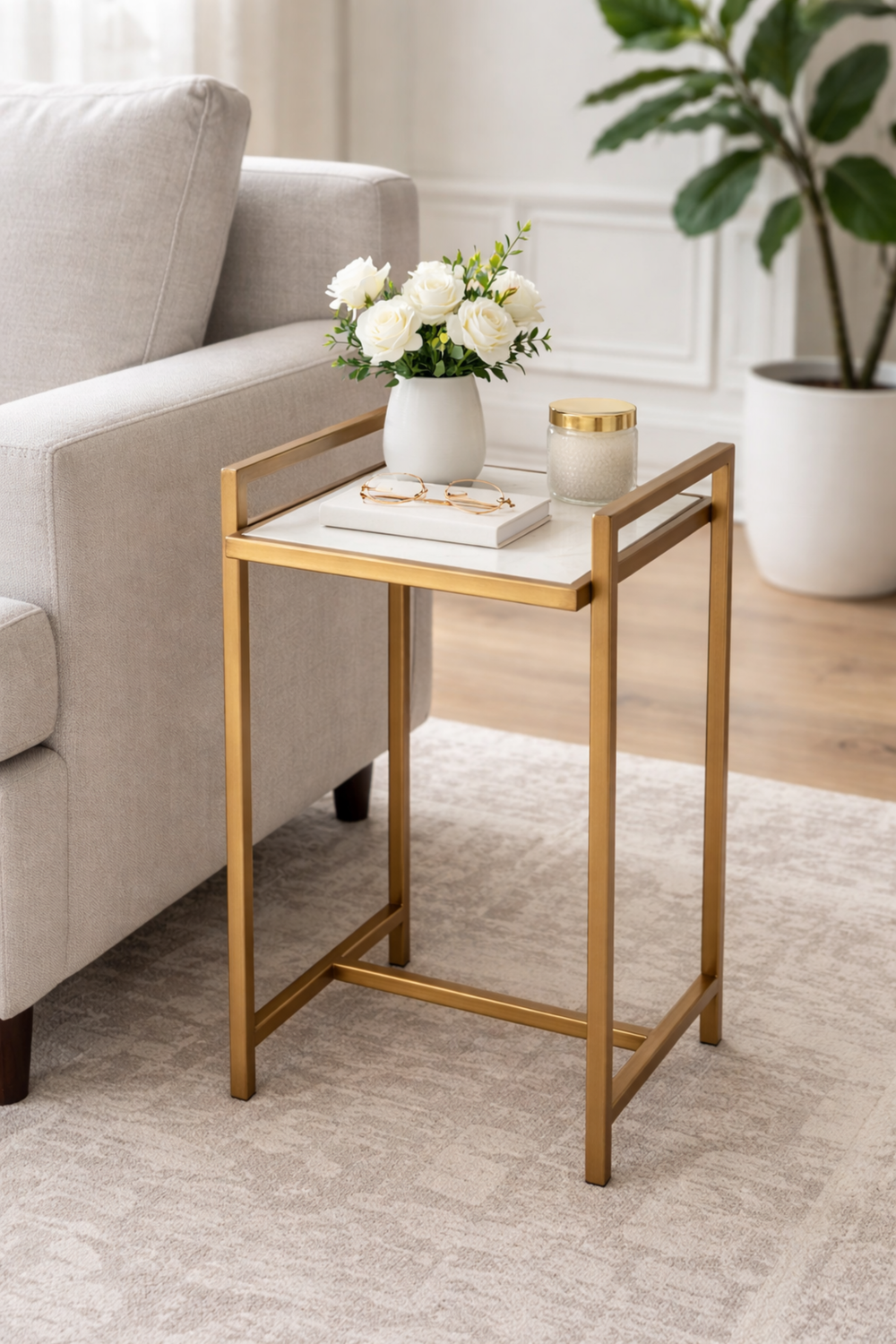 Gold side table with a white surface in a living room setting