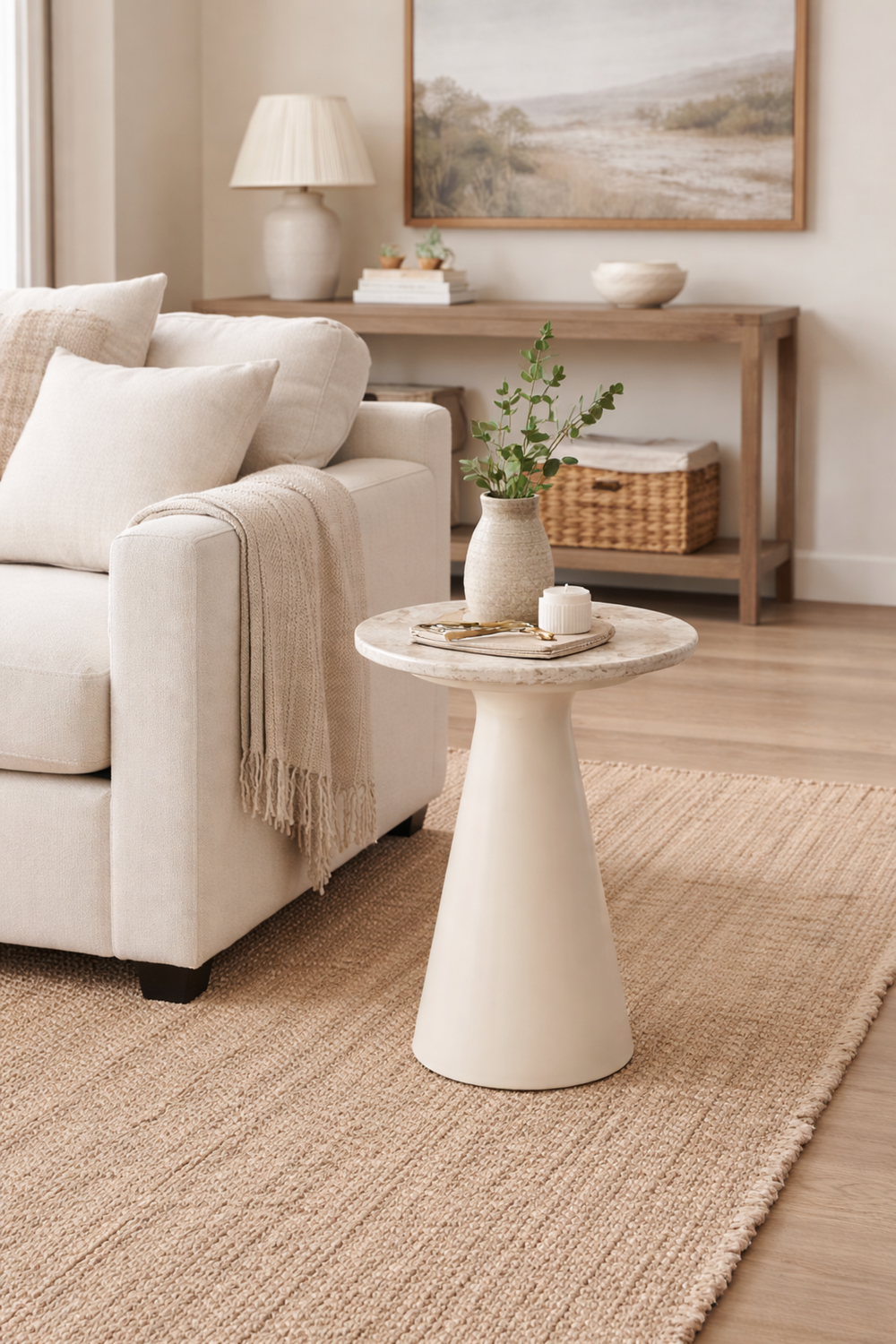 Living room with beige sofa, side table, and decorative items.
