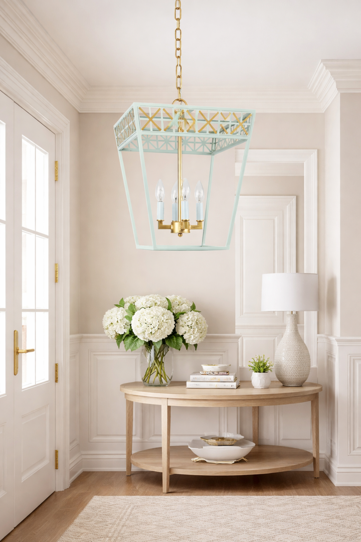 Elegant interior with a chandelier, table, and flowers in a well-lit room.