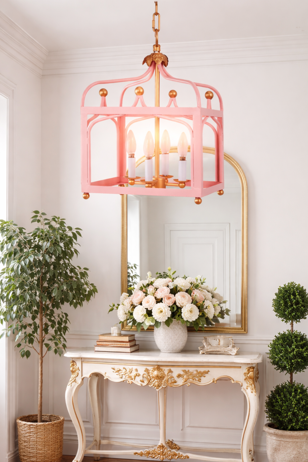 Pink pendant light fixture in a room with a mirror, table, and decorative plants.