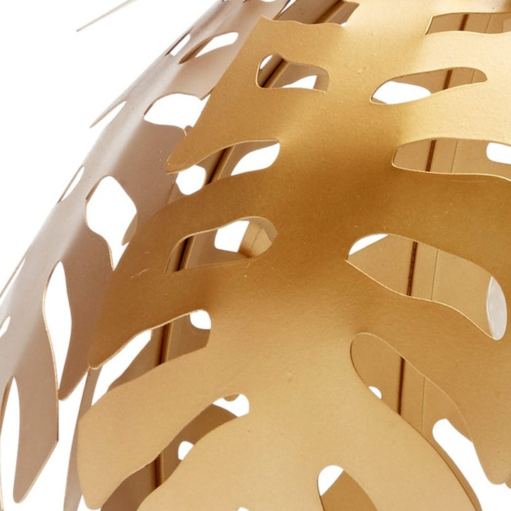 Gold tropical leaf pendant light shade close-up with leaf cutouts