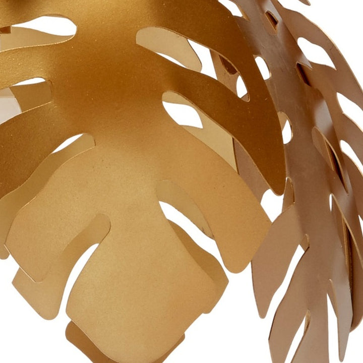 Gold tropical leaf pendant light metal leaf cutout pattern, close-up
