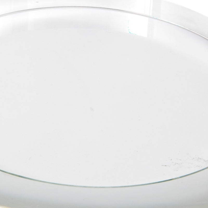 Clear round crystal riser, top view of smooth circular surface and rim