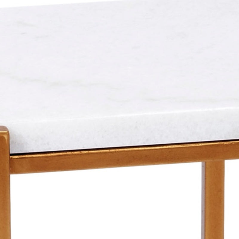 Gold metal table frame rail under a rectangular top