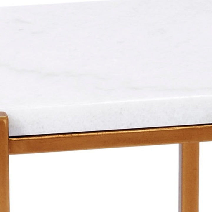 Gold metal table frame rail under a rectangular top