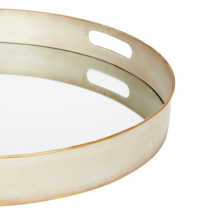 Round metal serving tray with two cutout handles and brushed gold rim, off-white finish