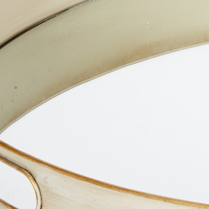 Off-white metal tray edge detail with brushed gold rim and subtle speckled finish