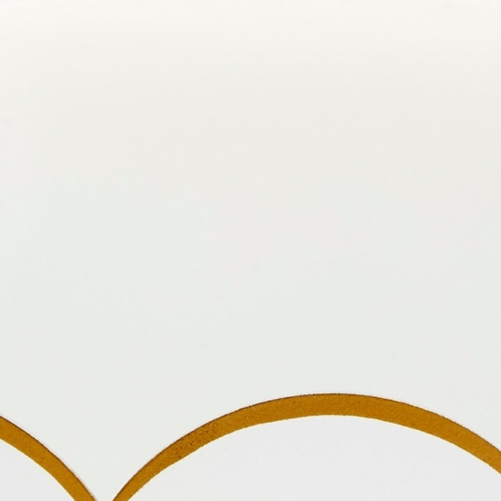 White glossy tray detail with gold scalloped trim curve