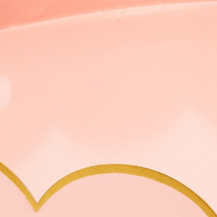 Gold scallop pattern detail on blush metal tray