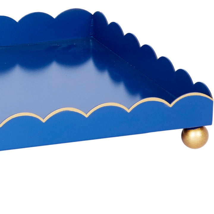 Blue rectangular metal tray end view with scalloped rim and gold corner knob