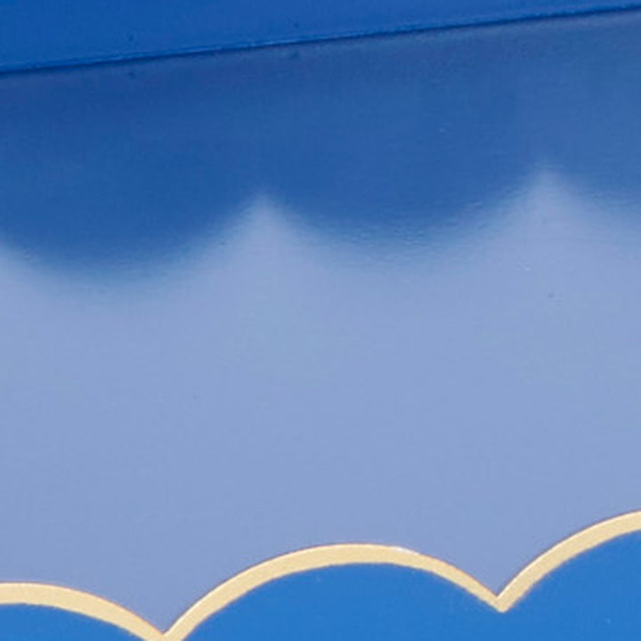 Close-up of blue rectangular metal tray with gold scalloped trim