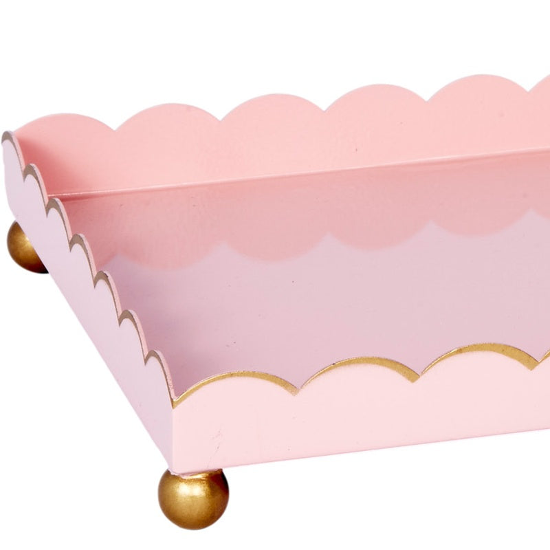 Blush pink rectangular metal tray with gold scalloped border and round gold feet
