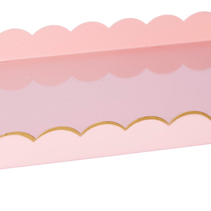Blush pink rectangular metal tray with gold scalloped trim along top edge