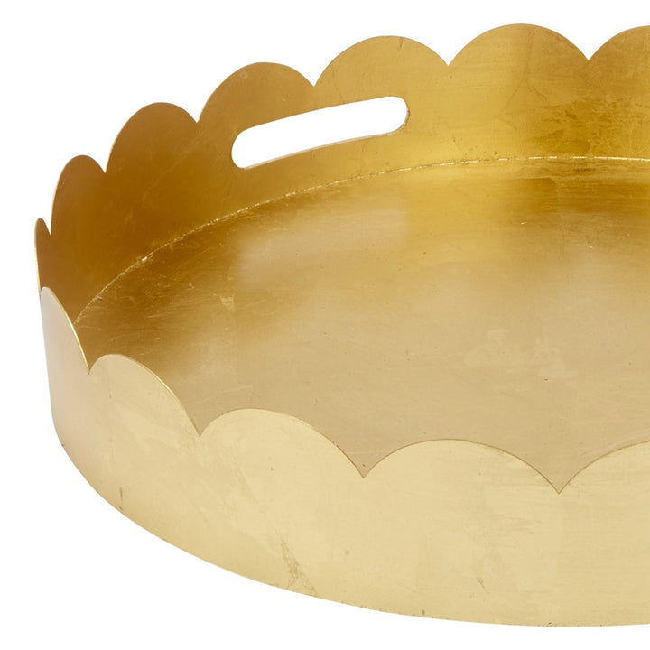 Gold scalloped metal tray with cutout handles, round shallow serving dish