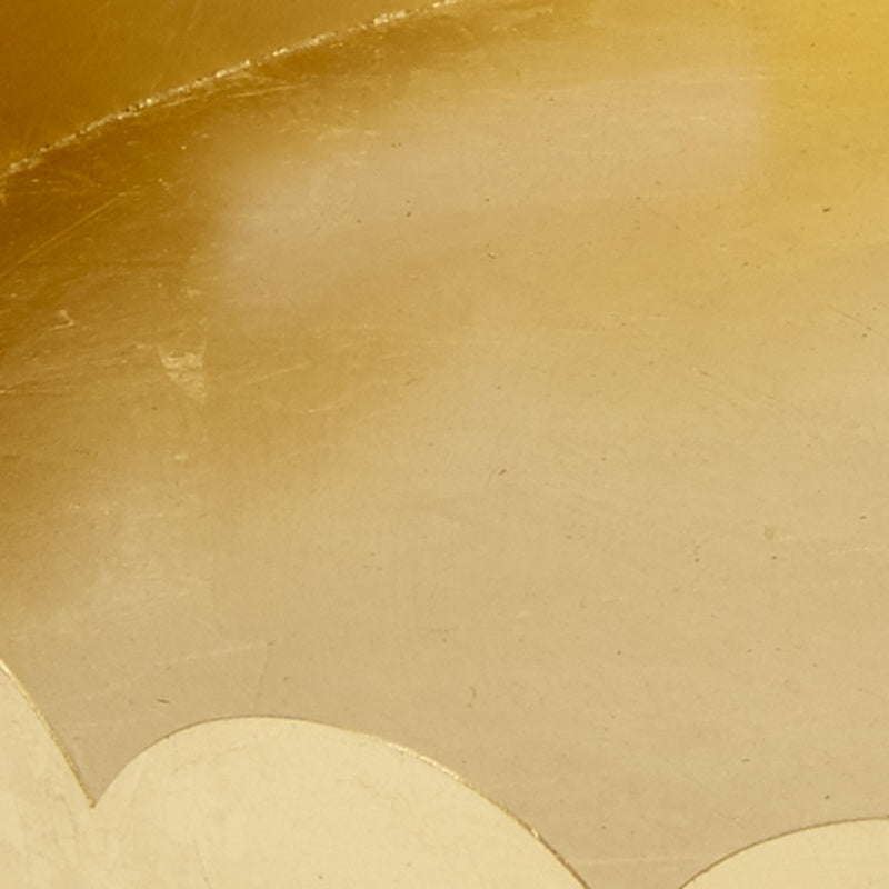 Gold metal tray interior with scalloped rim detail and brushed texture