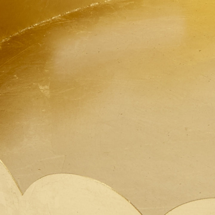 Gold metal tray interior with scalloped rim detail and brushed texture