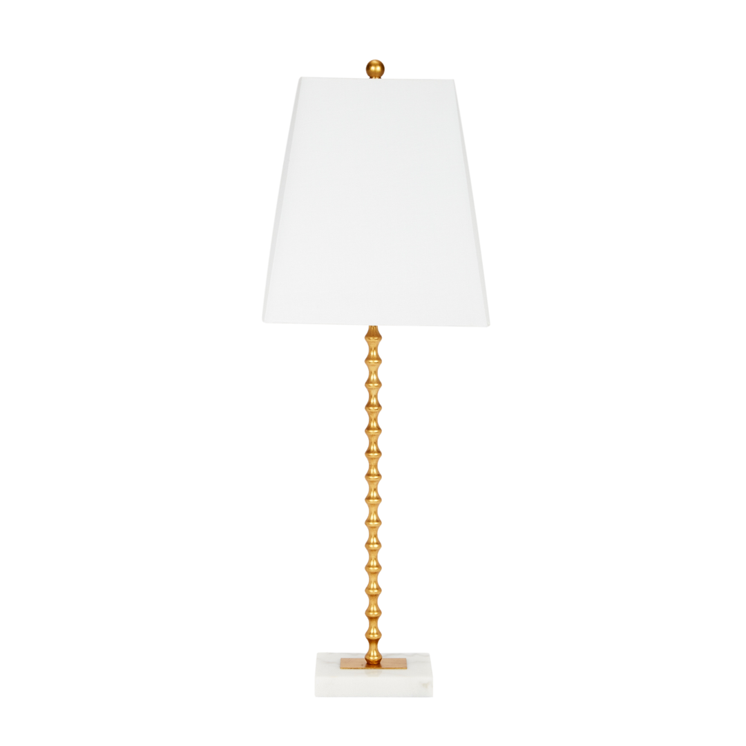 Gold spindle table lamp with white tapered shade and marble base, modern luxury home lighting on white background.