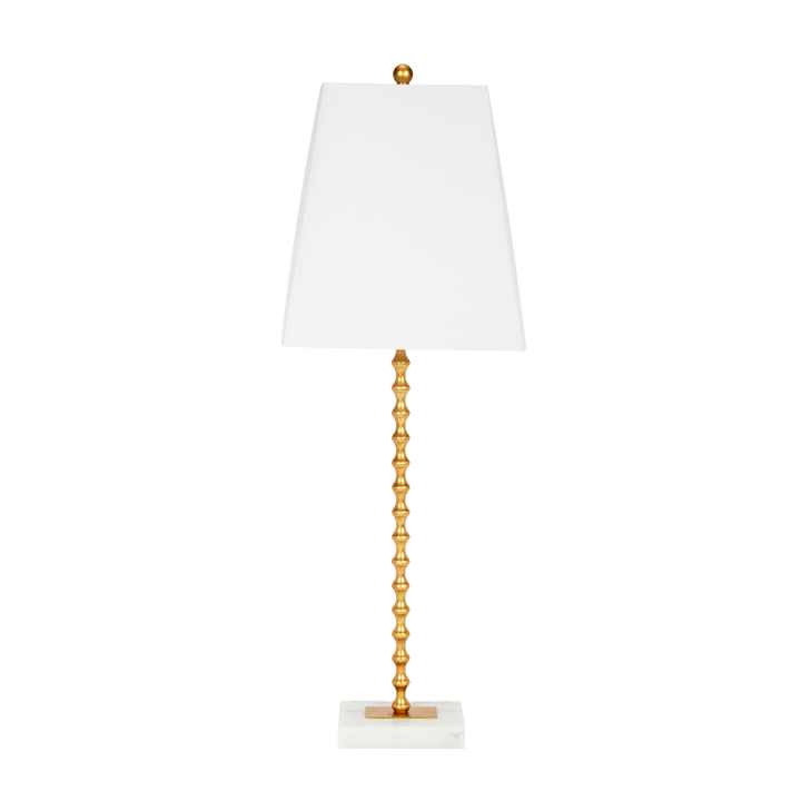 Gold spindle table lamp with white tapered shade and marble base, modern luxury home lighting on white background.