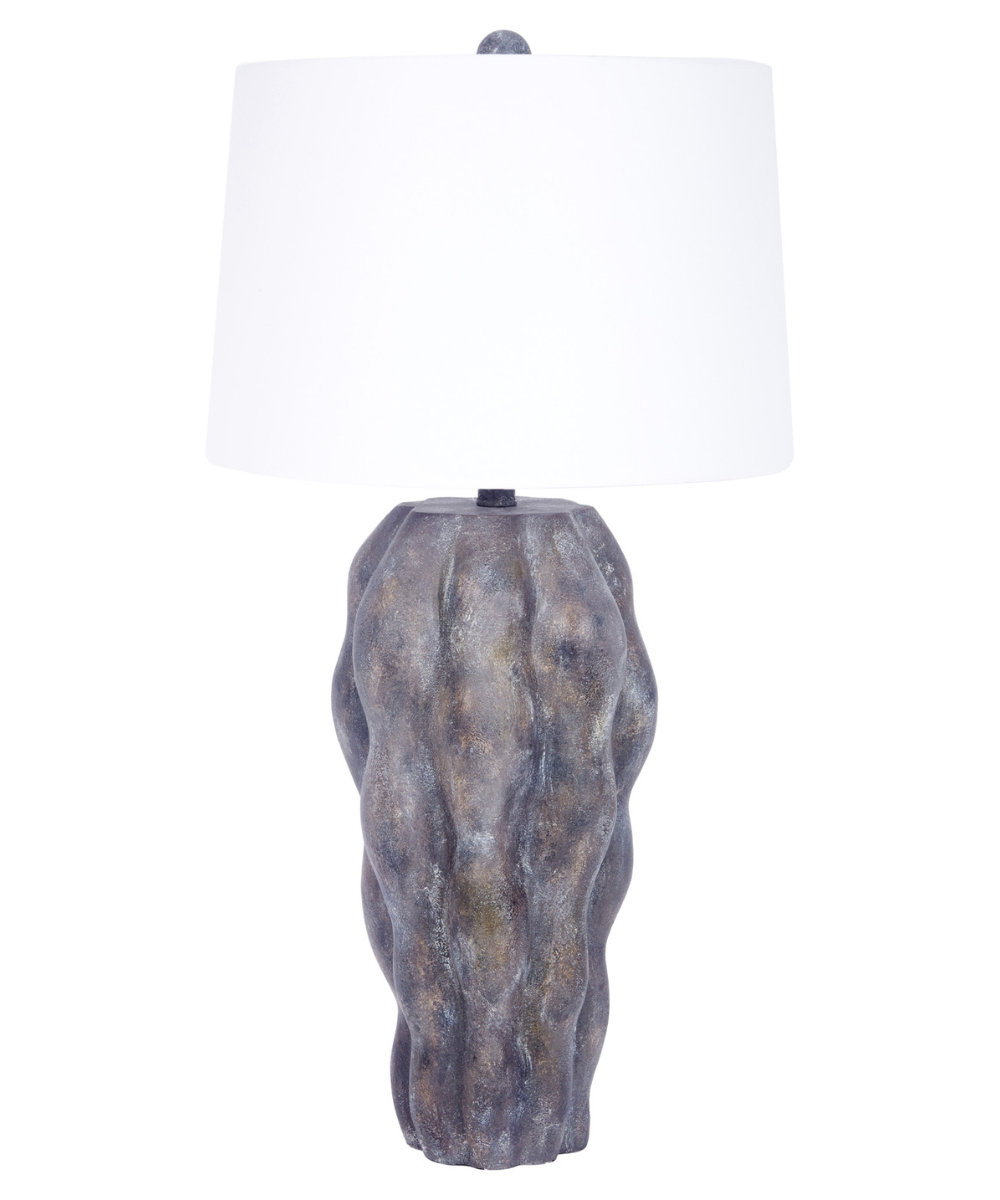 Modern sculptural table lamp with textured stone-style base and white drum shade, organic rustic home decor lighting.