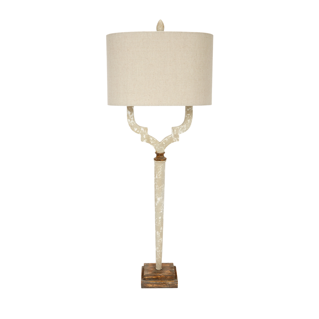 Vintage distressed cream table  lamp with beige drum shade and rustic wood base on white background