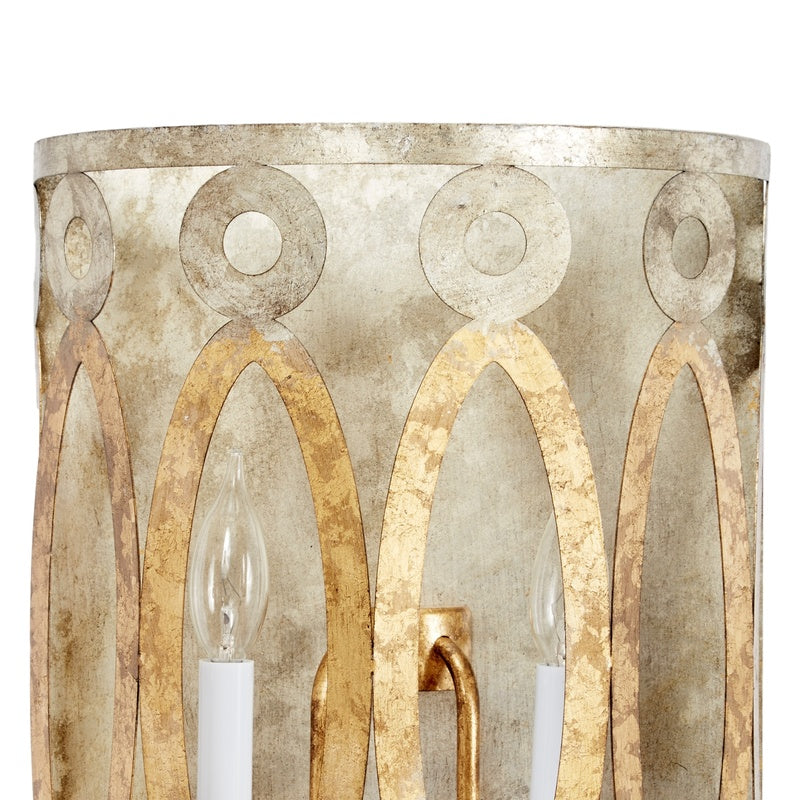 Aged gold metal dual-light wall sconce with ornate oval cutouts and two bell bulbs