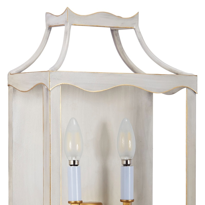 Cream and gold metal wall sconce with two clear bulbs and fluted frame