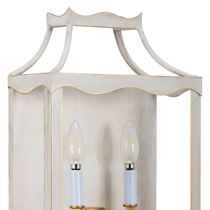 Cream and gold metal wall sconce with two clear bulbs and fluted frame