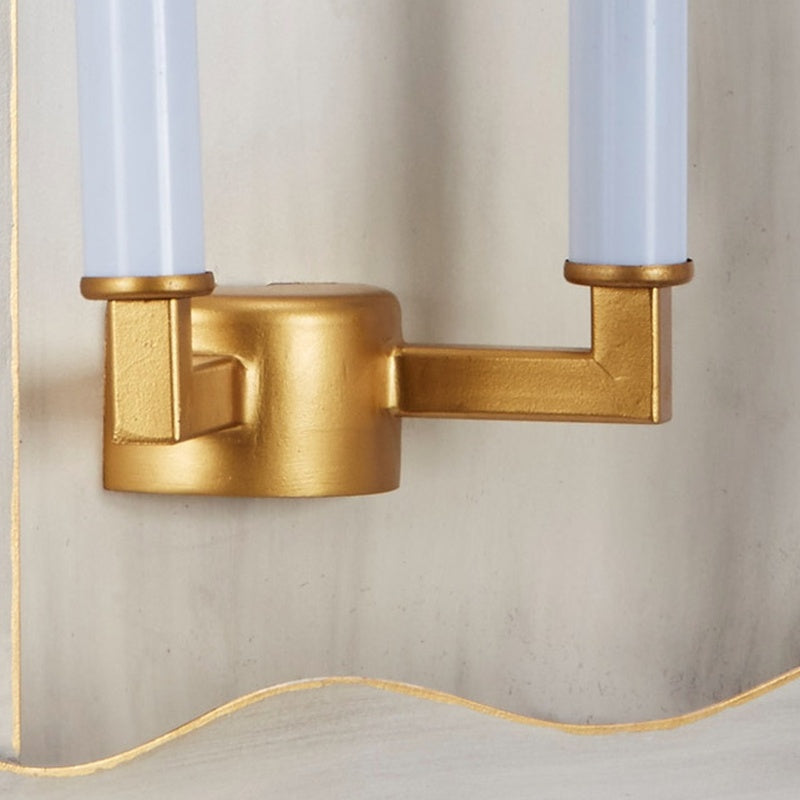 Gold wall sconce backplate with two clear glass bulb tops and bases