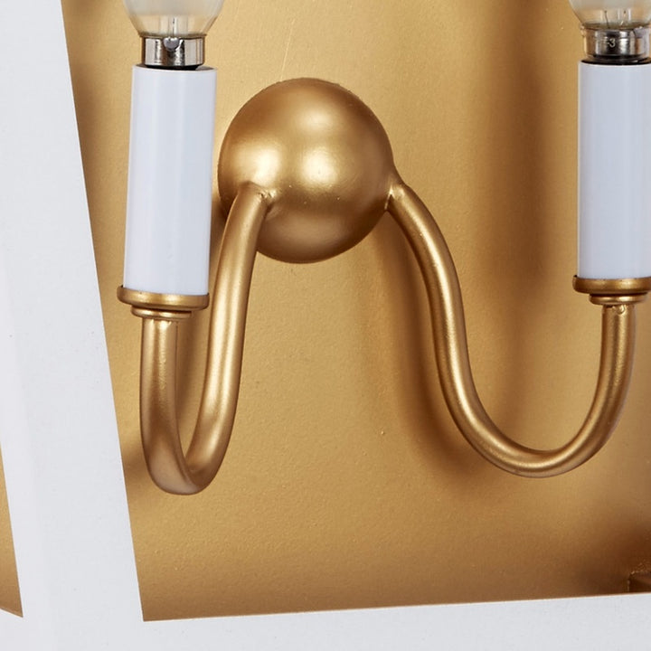 Dual-light wall sconce with white glass shades and gold curved metal arms